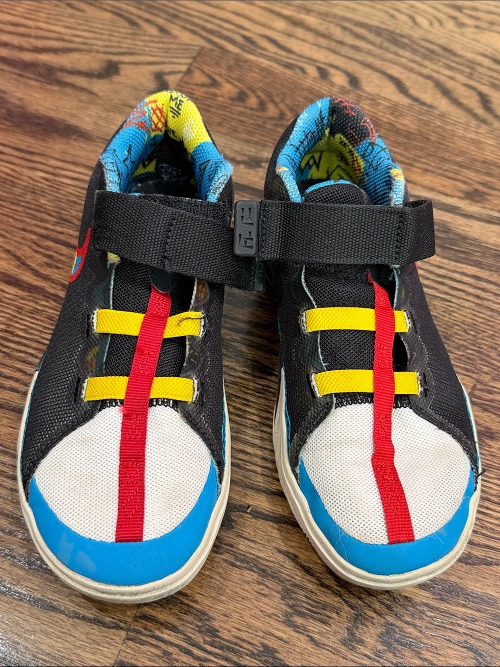 Nike Kids Black Sneakers with Blue, Red and Yellow Accents